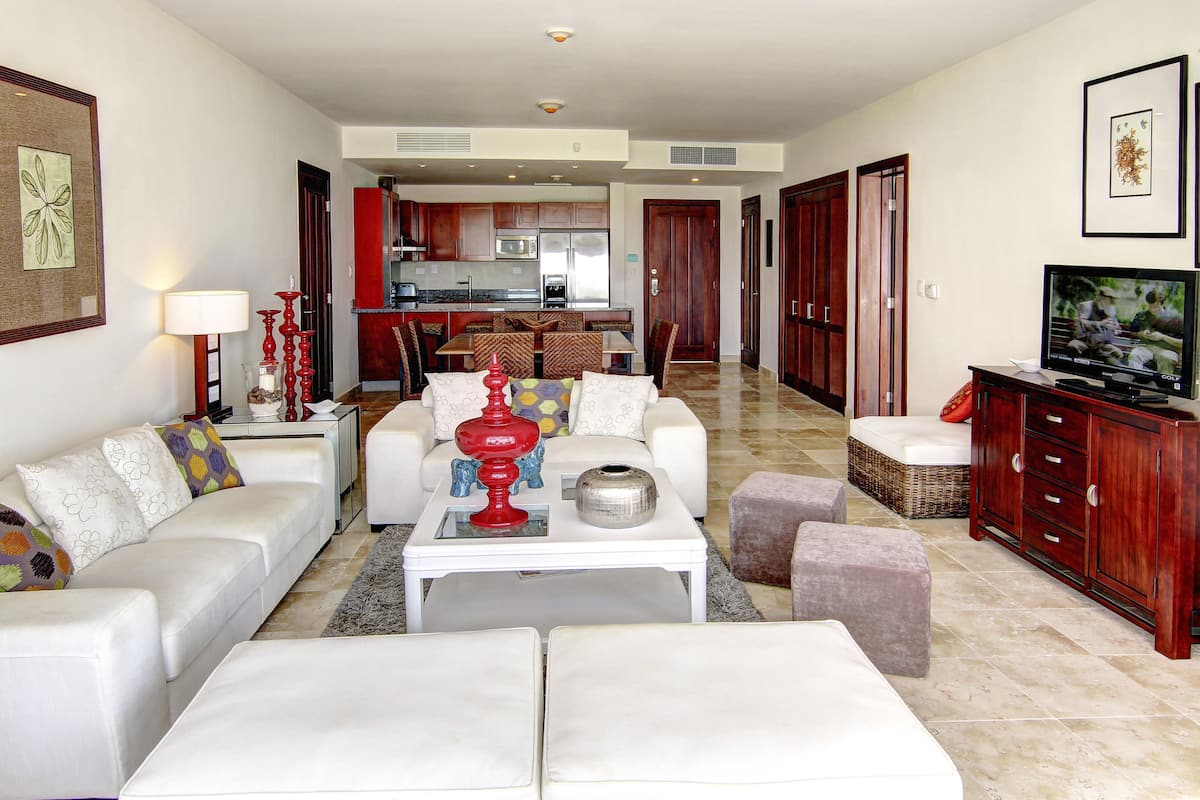 A spacious living area with a sofa, a coffee table, and a television.