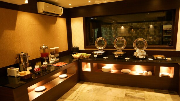 A breakfast buffet area with a variety of food items and a coffee station. - Hotel Mars Classic (Chennai)