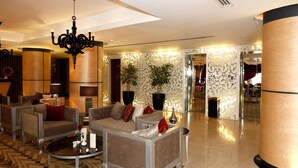 A spacious lobby with a chandelier, sofas, and a coffee table. - Grand Plaza Hotel - Takhasosi Riyadh (Riyadh)