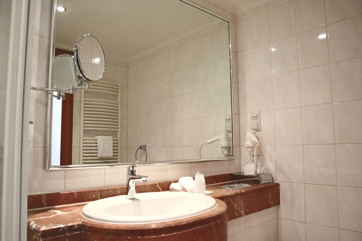 suite, 1 double bed, sauna, river view | bathroom | deep-soaking bathtub, free toiletries, hair dryer, towels