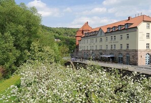 A historic building with a traditional European architectural style, featuring a prominent tower and multiple windows. - Alter Packhof (Hann. Muenden)