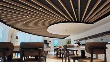 A modern interior with a curved ceiling, seating area, and a kitchen counter.