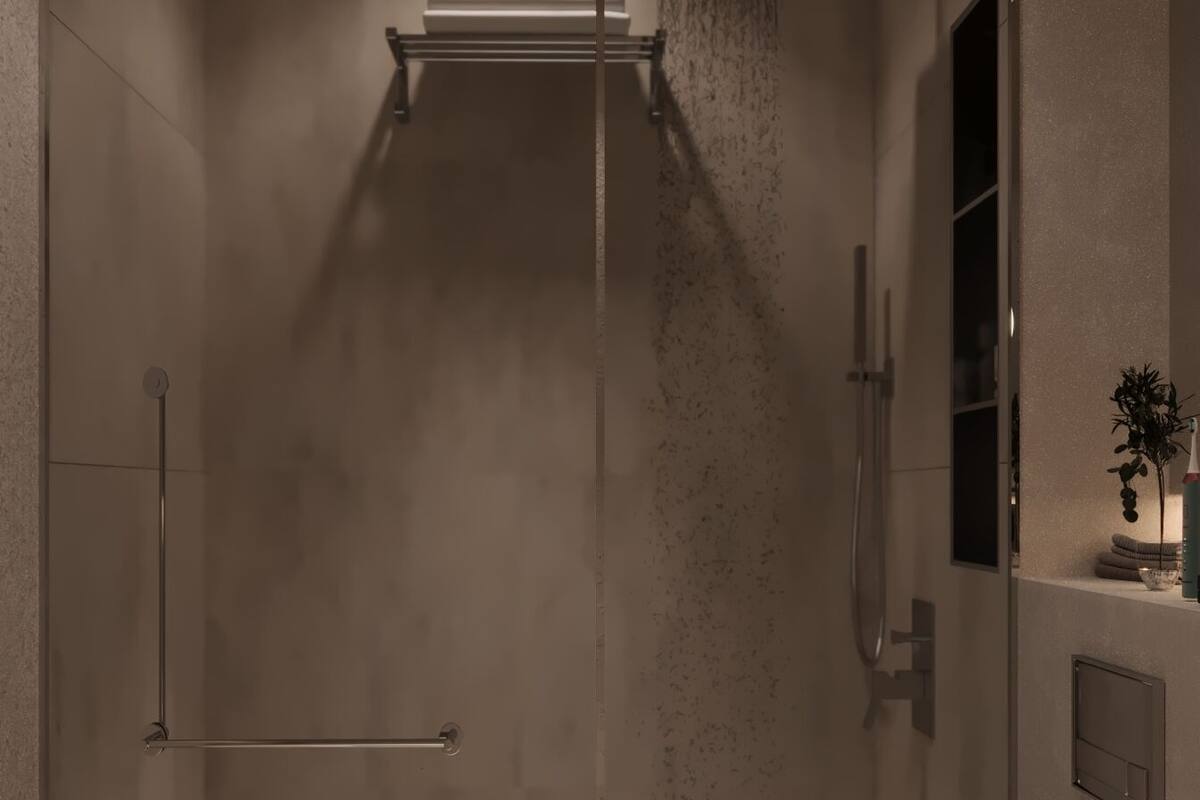 A modern bathroom with a glass shower enclosure, a white toilet, and a sink with a mirror.