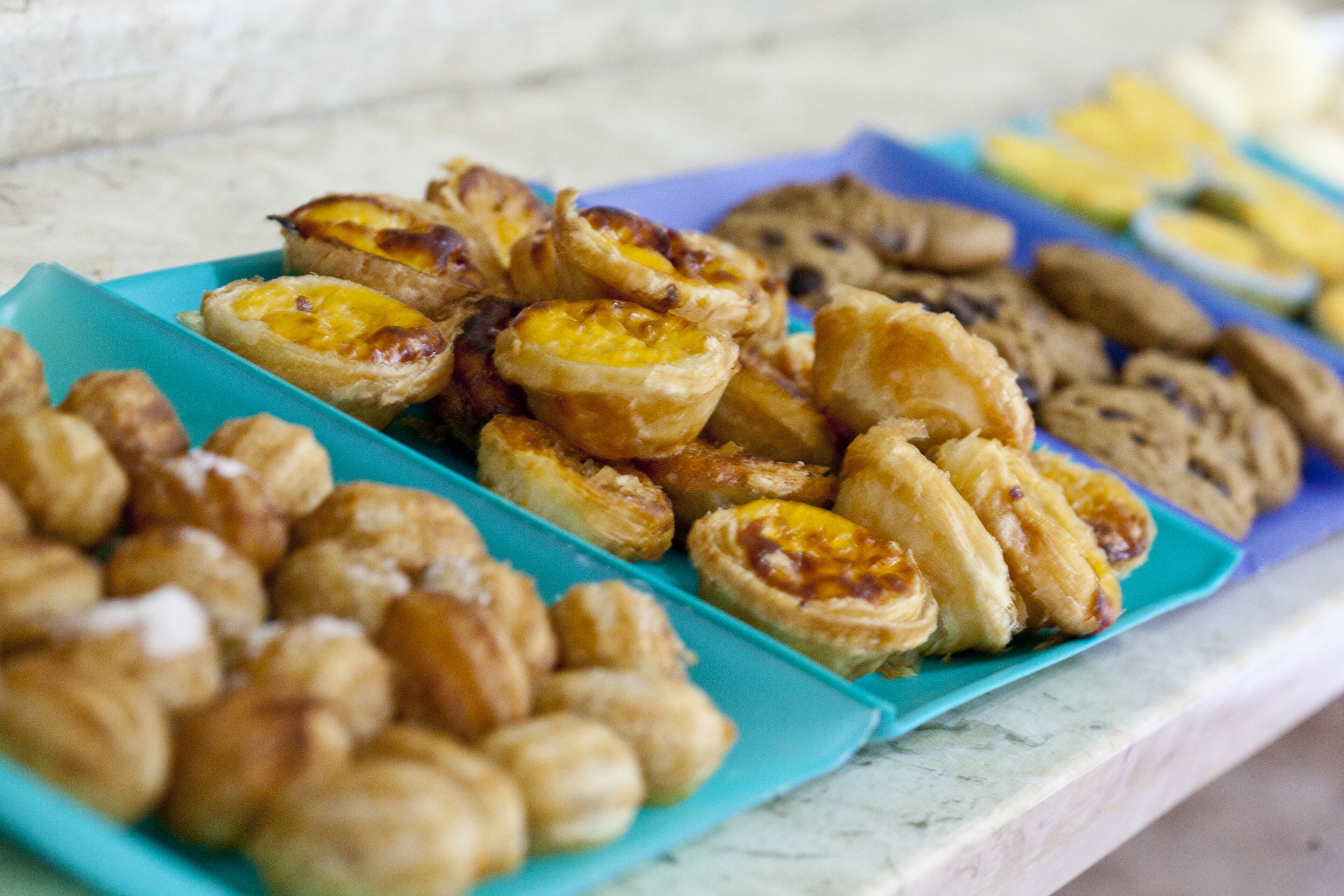 A variety of pastries on a blue tray.
