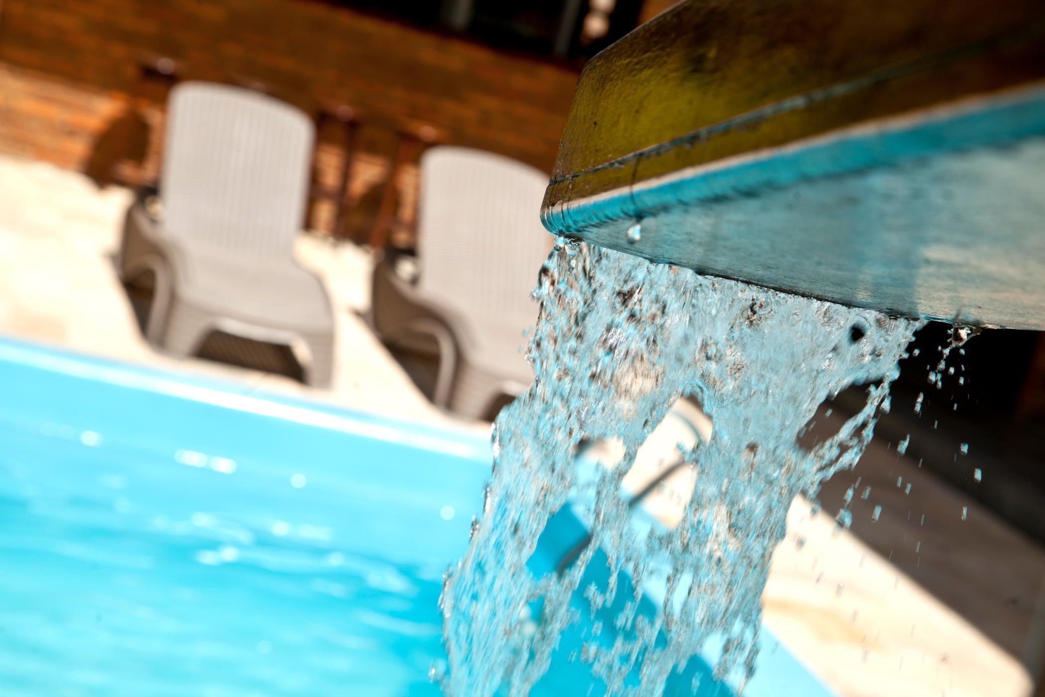 A pool with clear water and a metal edge.