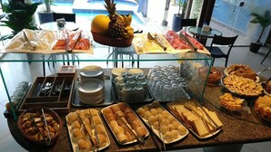 A buffet with various food items and utensils.