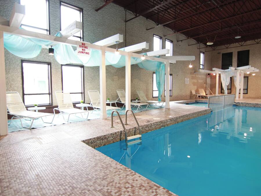 Indoor pool, open 9:00 AM to 10:00 PM, pool umbrellas, pool loungers