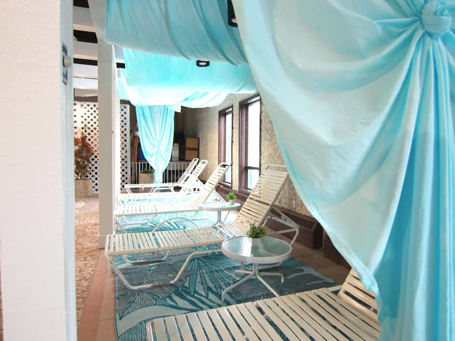 Indoor pool, open 9:00 AM to 10:00 PM, pool umbrellas, pool loungers