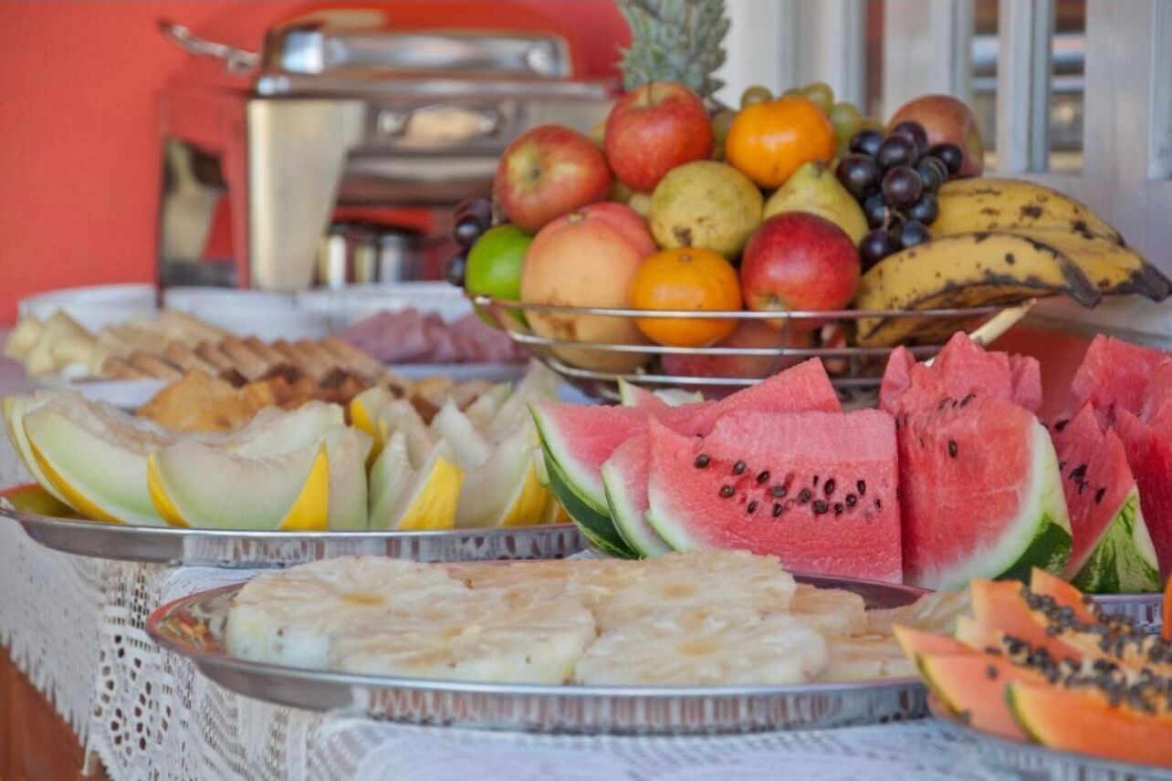 A table with various fruits and pastries.
