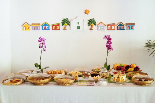 A buffet table with various food items and decorative elements.