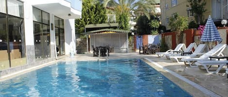 Outdoor pool, pool umbrellas, sun loungers