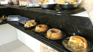 Een buffet met diverse gebakken producten, zoals brood, broodjes en taarten.