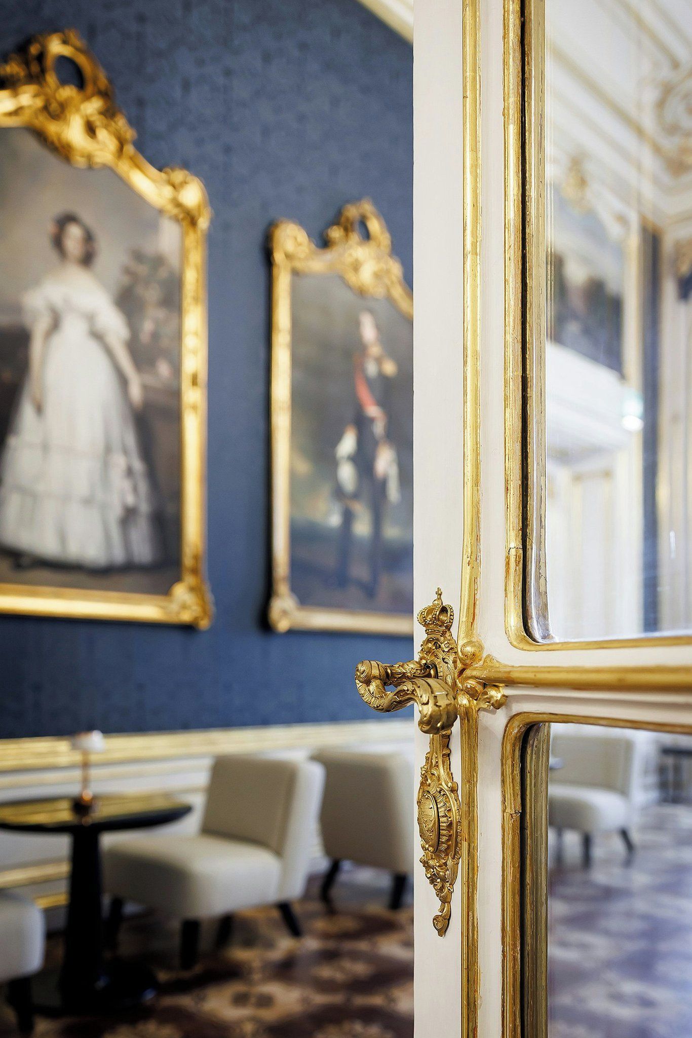 A room with ornate golden frames and a patterned carpet.