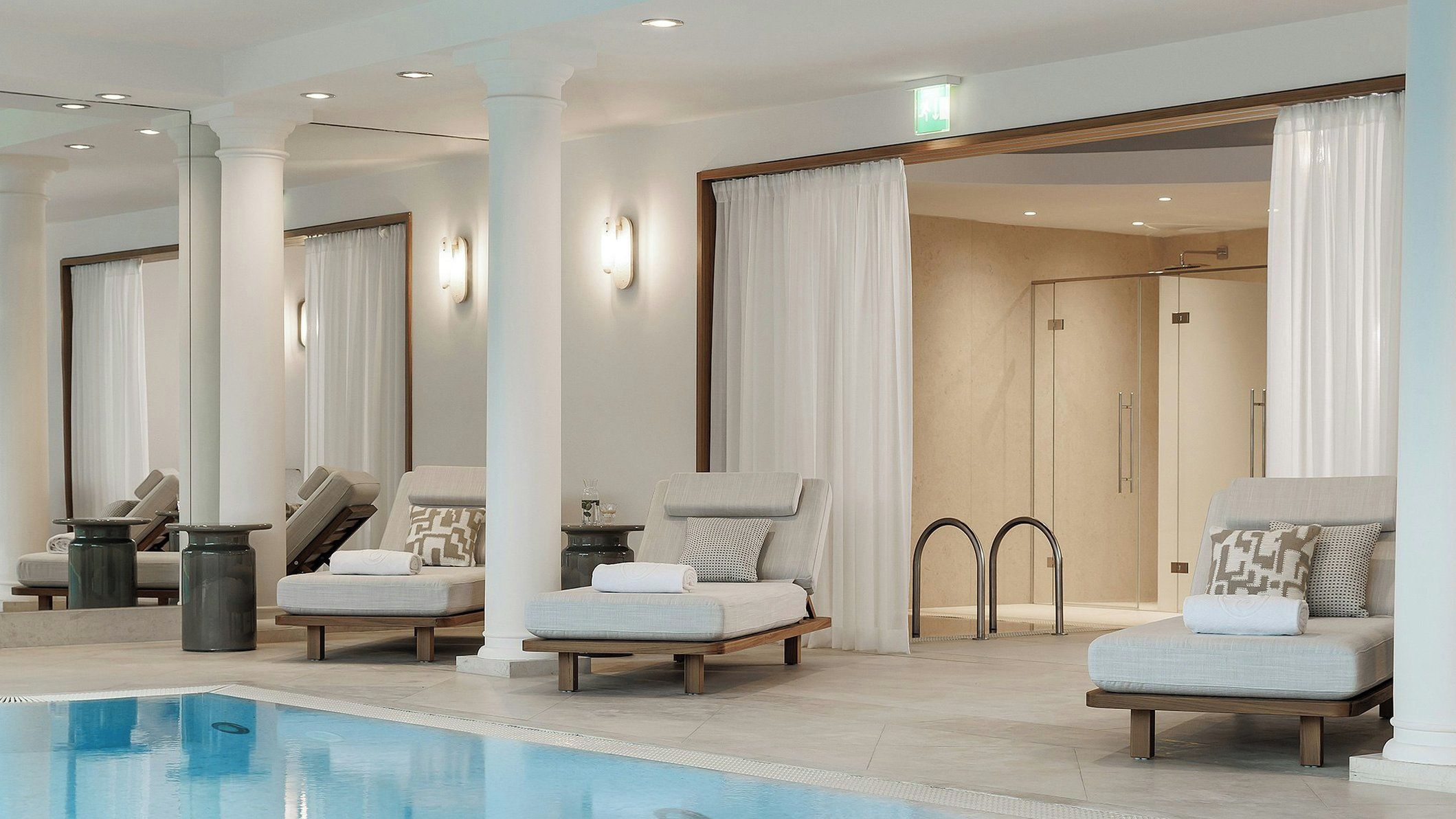 Un espace aménagé au bord de la piscine, avec des chaises longues et une piscine à l’eau d’un bleu cristallin.