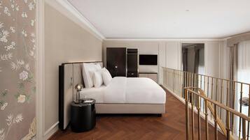 A bedroom with a bed, bedside table, and a TV.