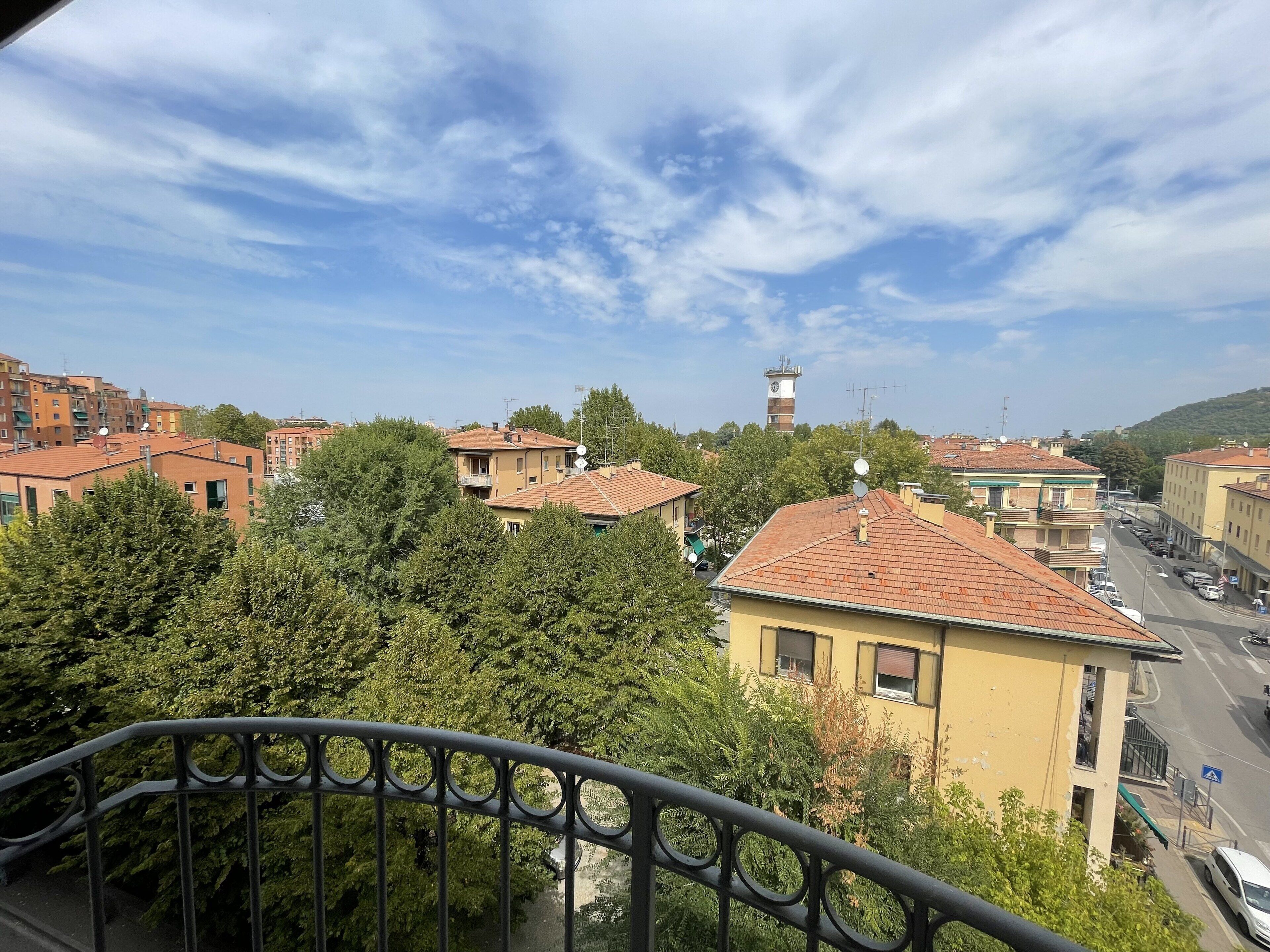 A residential area with buildings, a tower, and a street.
