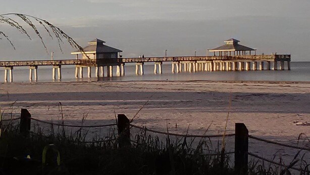 A pier extending into the water with two structures at the end, likely for observation or rest. - Silver Sands Villas (Fort Myers Beach)