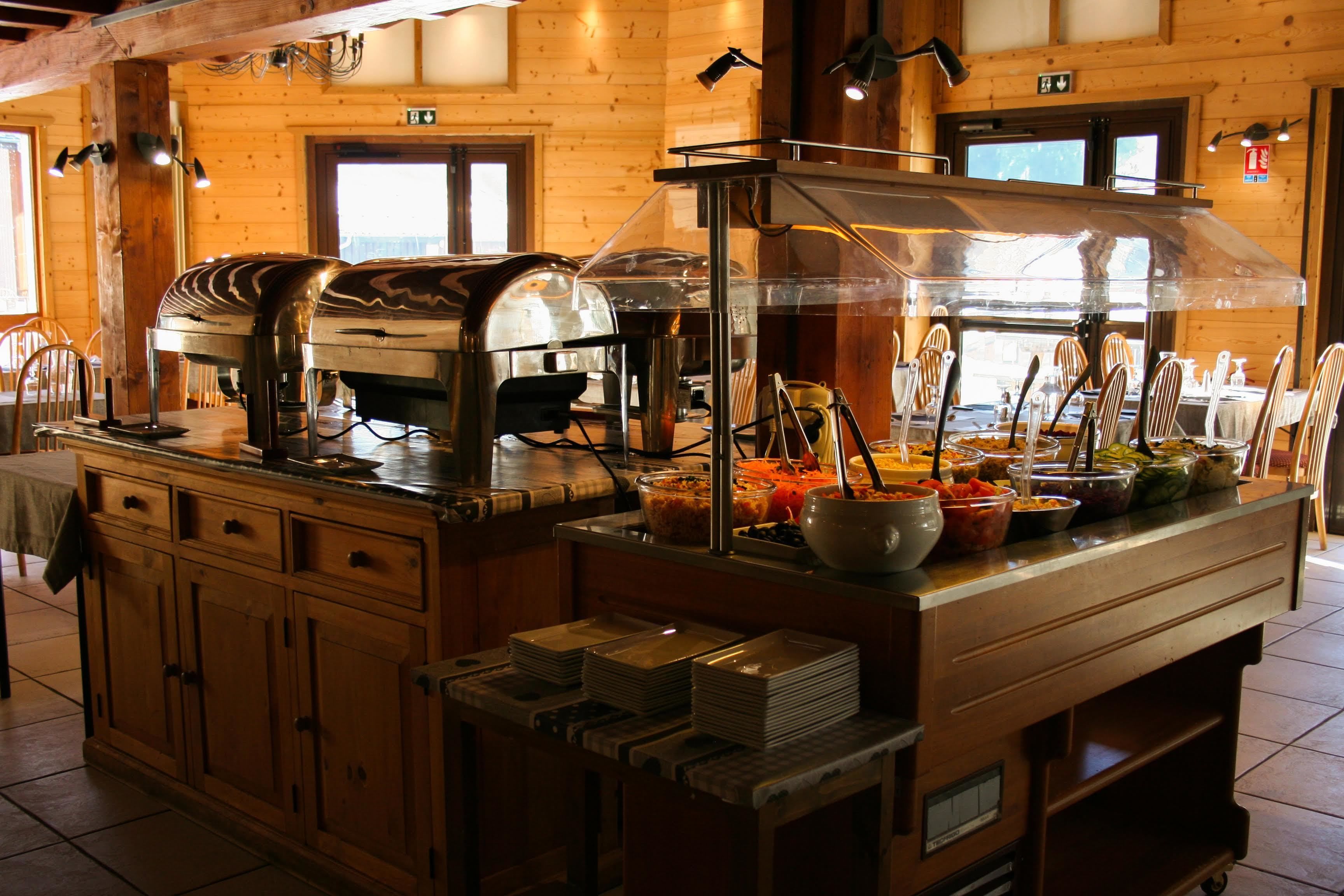 A buffet setup with a variety of food items and a coffee machine.