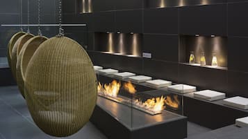 Relax in a warm, inviting space with a central fire feature and cozy seating areas.
