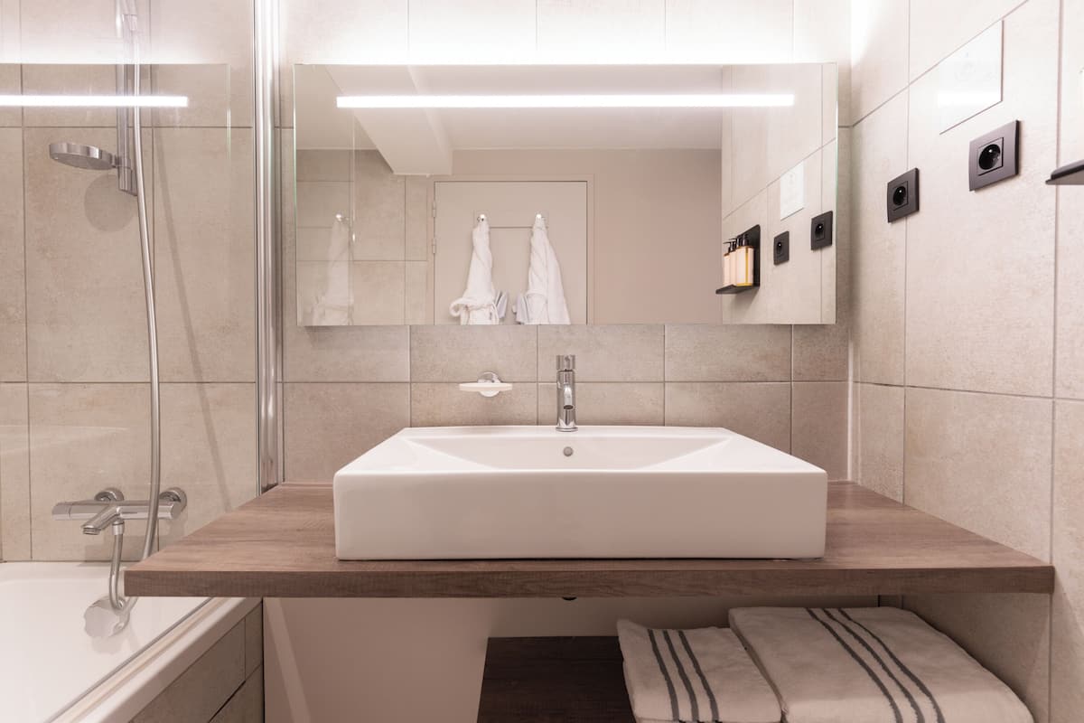 bathtub, hair dryer, bathrobes, slippers