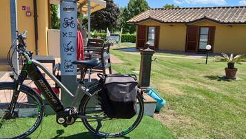 A bicycle parked next to a self-service bike station with a sign indicating bike, air, and wash services.