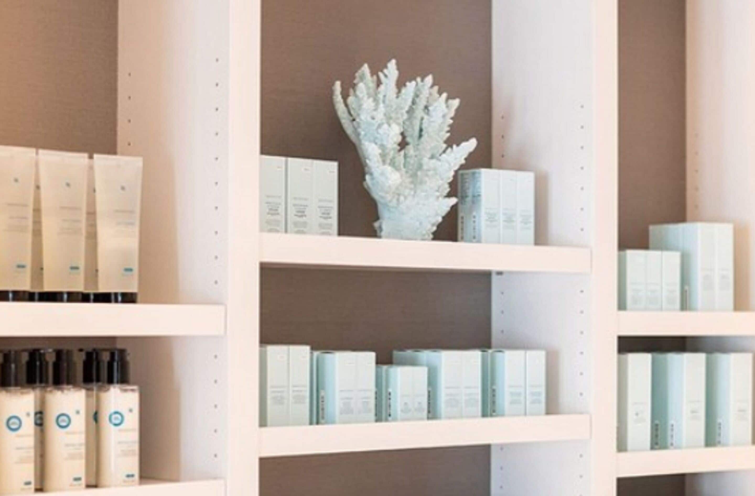 A shelf with neatly arranged skincare products.