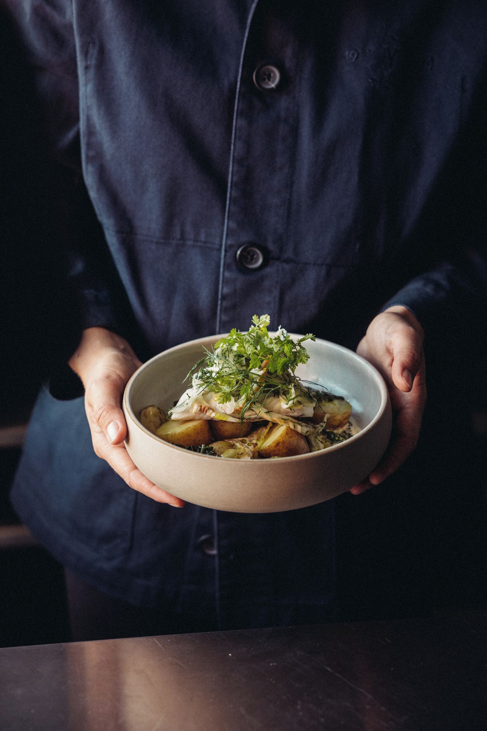 A person holding a bowl of food.