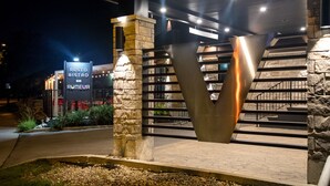 A modern building with a stone facade and a prominent entrance. - Hotel V (Gatineau)