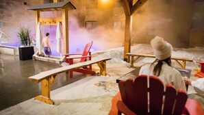 An indoor sauna with wooden benches and a steam room. - Hotel V (Gatineau)