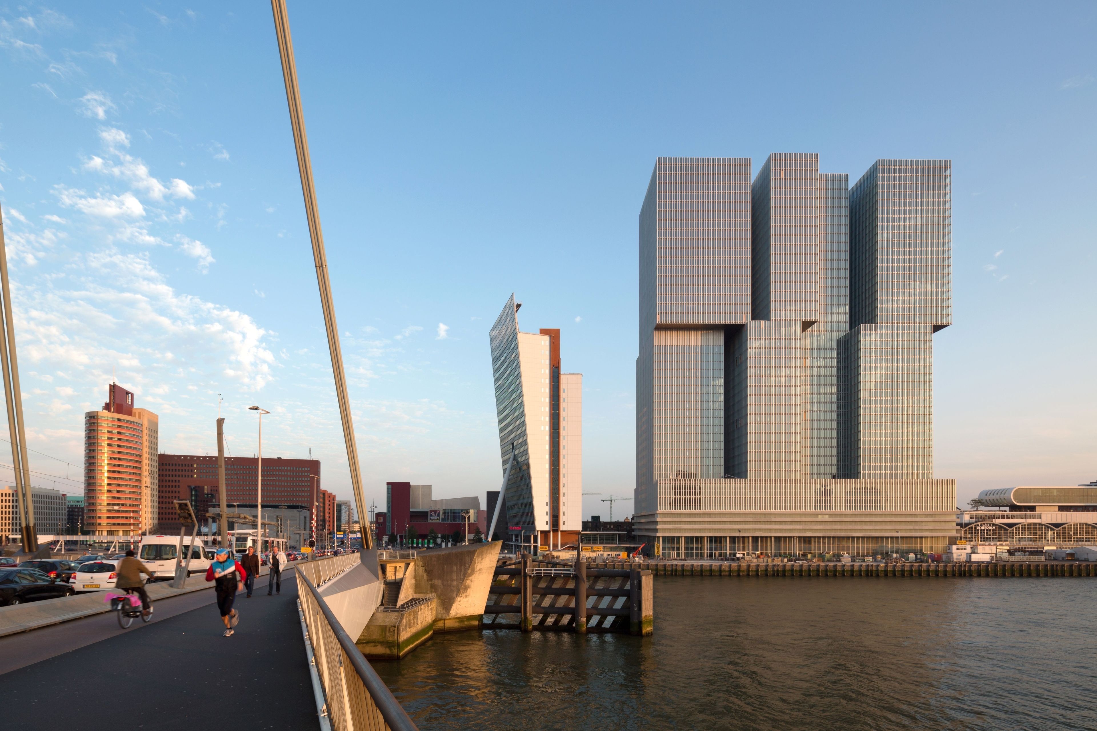 A modern bridge with a pedestrian walkway and a river.