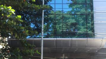 Reflecting the lush surroundings, The Lotus Apartment Hotels features a sleek glass facade and a welcoming entrance.