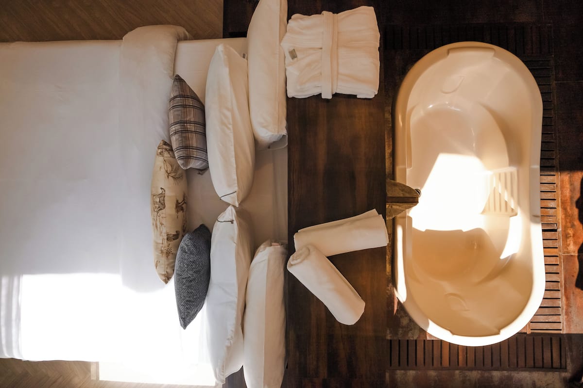 A neatly arranged bathroom with a bathtub, a sink, and a mirror.