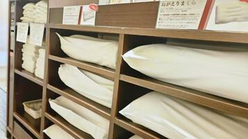 A store shelf with neatly folded white towels.