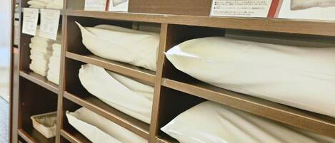 A store shelf with neatly folded white towels.