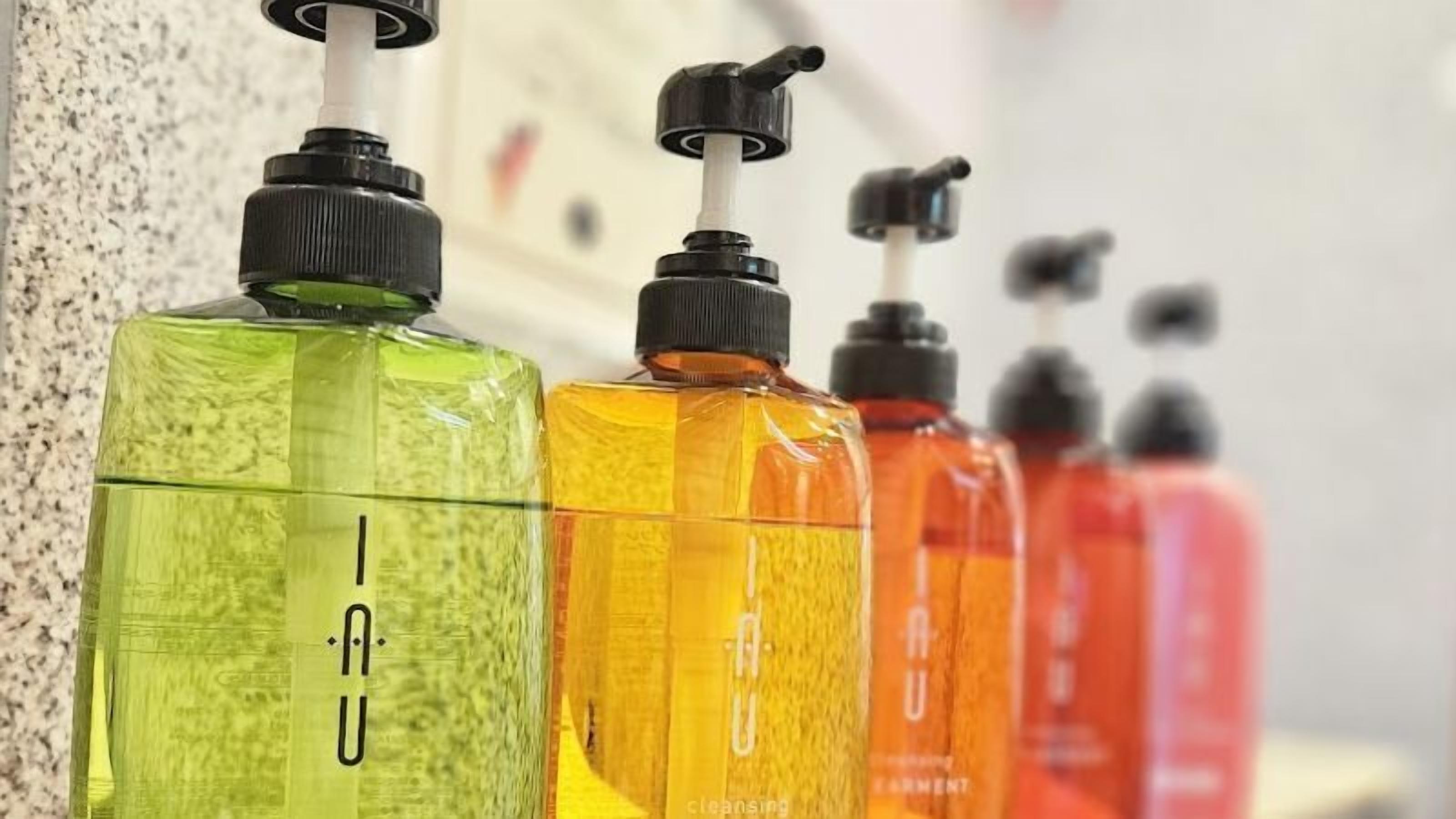 A row of hand sanitizer bottles in various colors.