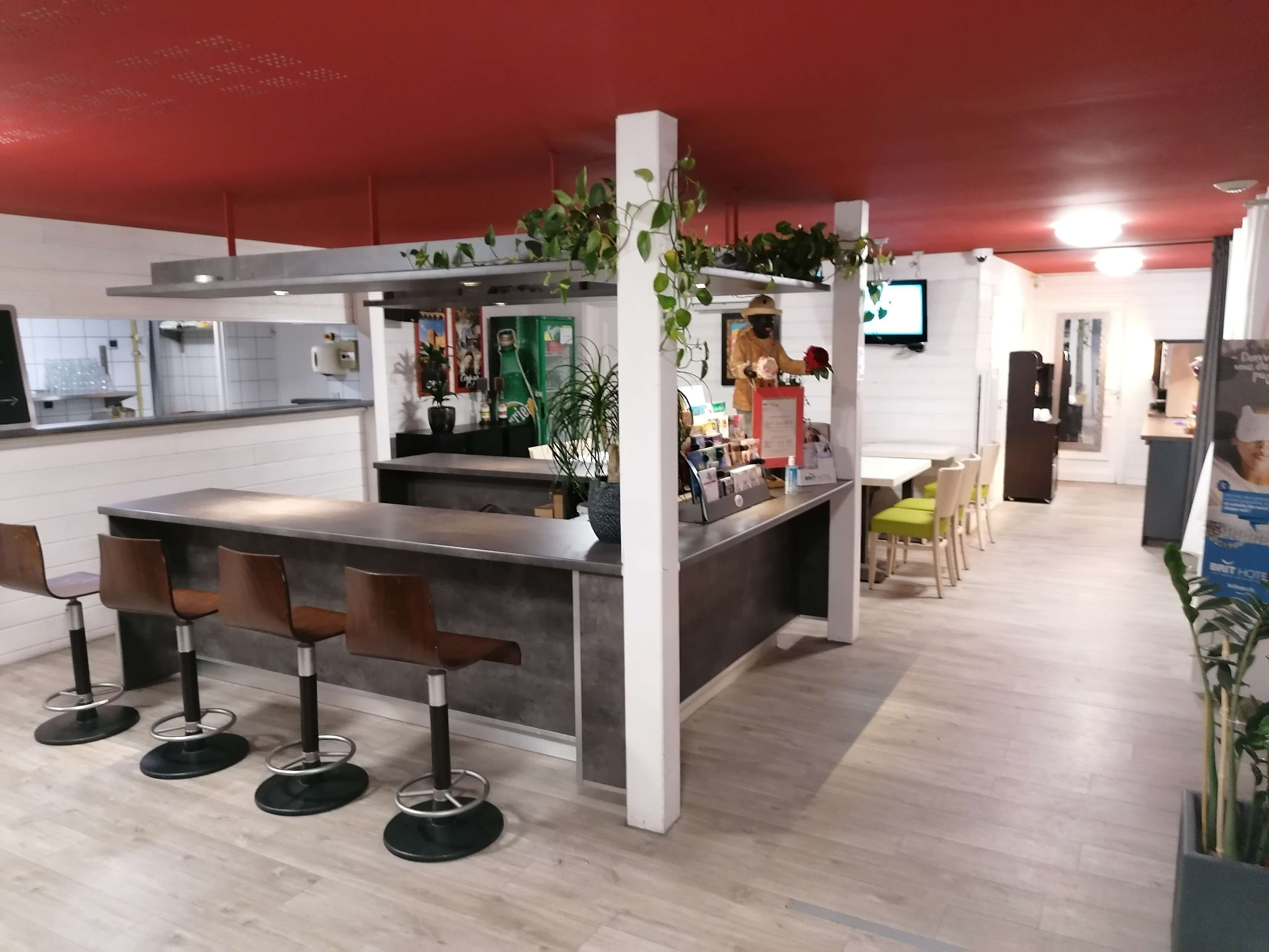 A modern bar area with a counter, bar stools, and a seating area with chairs.