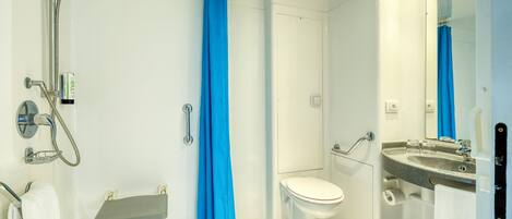 A modern bathroom with a shower, toilet, and sink.
