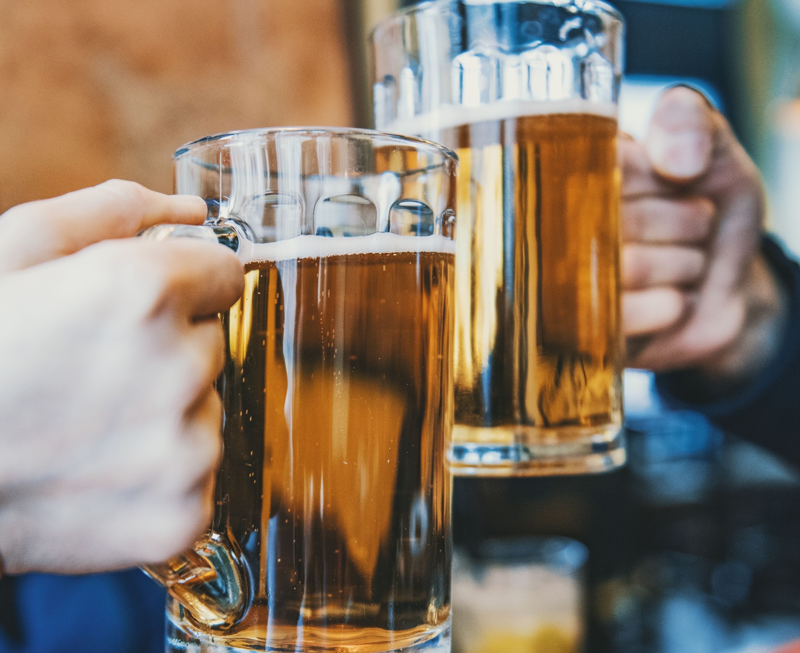 Deux personnes tenant des chopes de bière.