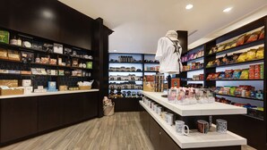 A store with shelves stocked with snacks, shoes, and other items. - Homewood Suites by Hilton Nashville Vanderbilt, TN (Nashville)