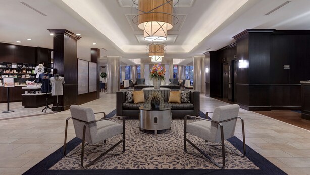 A spacious lobby with a central seating area, a reception desk, and a large chandelier. - Homewood Suites by Hilton Nashville Vanderbilt, TN (Nashville)