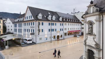 A large white building with a sign reading "Hotel".