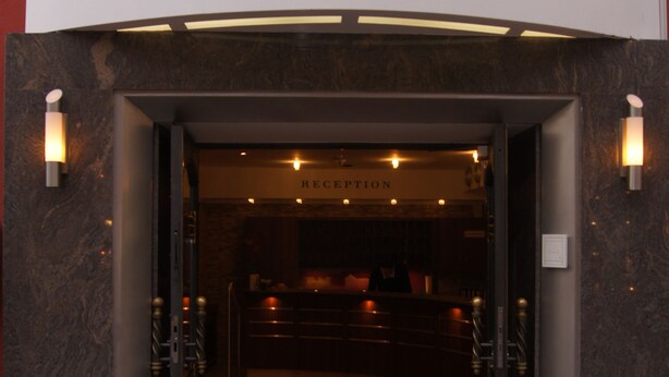 The entrance to Hotel Kufsteinerhof with a reception area visible inside. - Hotel Kufsteinerhof (Kufstein)