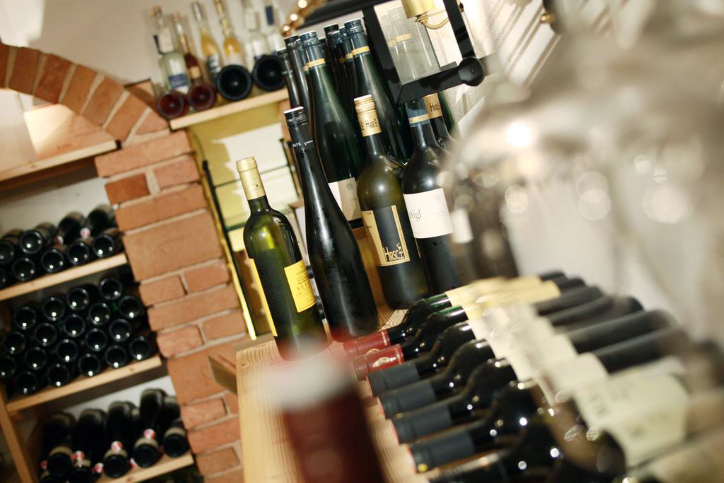 A wine cellar with various bottles and wine racks.