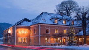 Un hotel con un letrero que dice "Hotel Erber" y un paisaje cubierto de nieve al fondo.