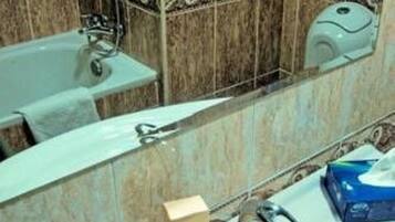 A bathroom with a sink, mirror, and a towel rack.