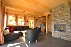 Luxury Chalet, 4 Bedrooms, Sauna, Mountain View | Living room | Flat-screen TV, fireplace