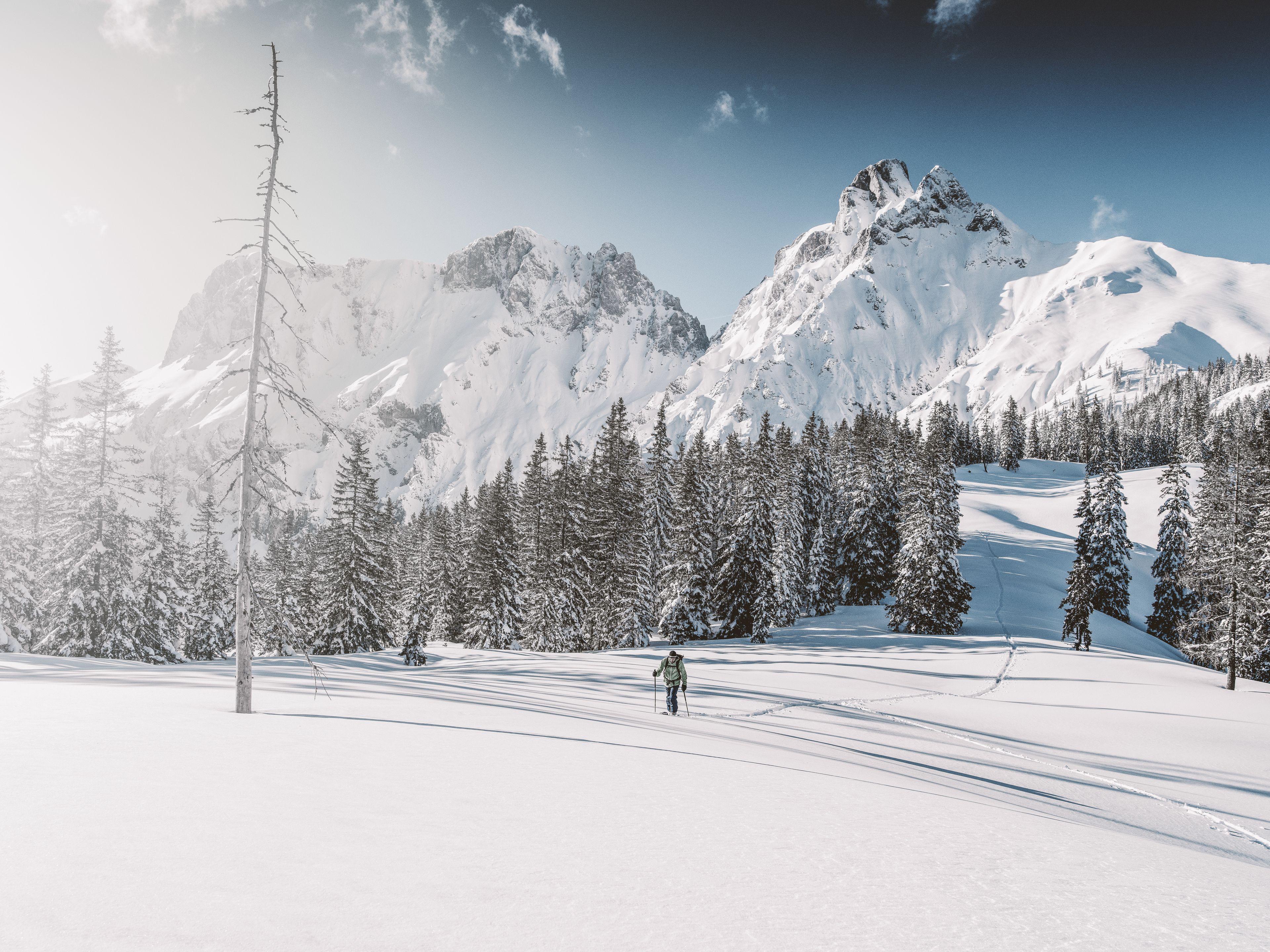 A snow-covered mountain landscape with a clear sky.