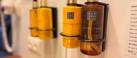 A display of Ritual of Meer hand and body lotion bottles in a hotel setting.