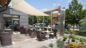 An outdoor seating area with wicker furniture and a canopy. - Hotel Garni Birkenhof (Bad Radkersburg)