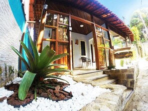 A building with a wooden exterior, large windows, and a sign that reads 'Pousada Guimarães.' - Pousada Guapuruvu (Angra dos Reis)